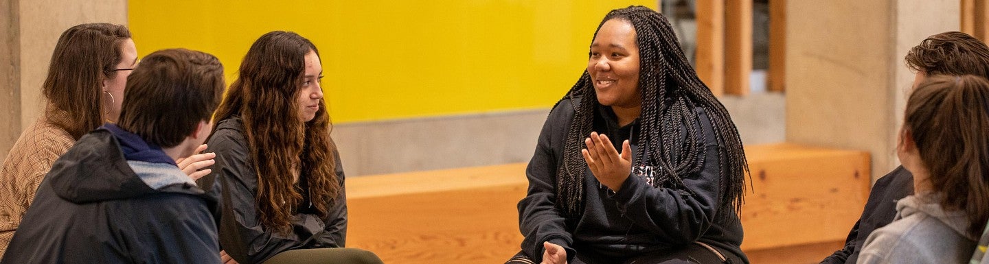 students sitting together in campus housing space