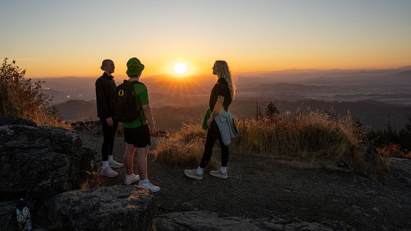 students on top of Spencer Butte at sunrise