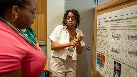 Maya Gach presenting a poster