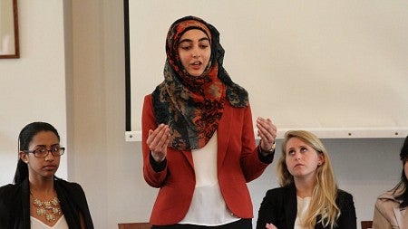 Female student in traditional headdress speaking at Oxford Consortium for Human Rights