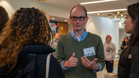 Larry Ulibarri speaking with scholars at the Distinguished Scholarship Homecoming Reception