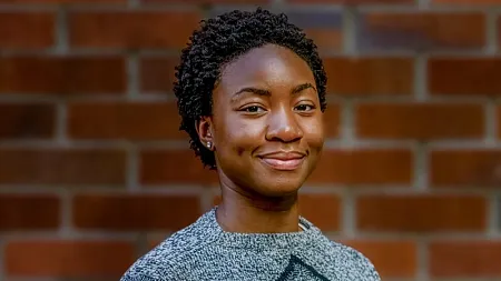 Valerie Owusu-Hienno, Rhodes Finalist. She has black curly hair, dark skin and wears a grey sweater.
