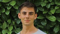 Headshot of Charles Petrik against leafy background