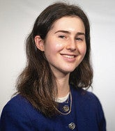 Beatrice Kahn has long brown hair