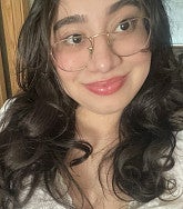 Yolett Lara Martinez has long black hair and glasses