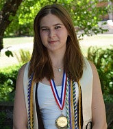 Benni Howard has long blond hair and wears multiple graduation stoles, cords and medals