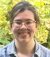Megan Yellowtail wears round clear framed glasses