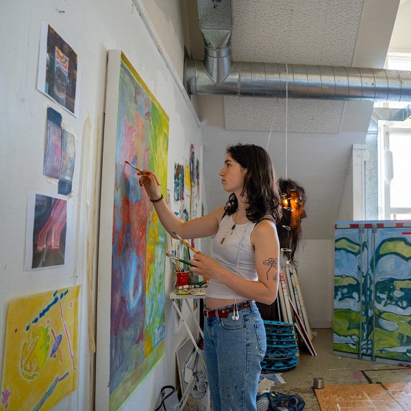 student works on painting in UO fine art studios