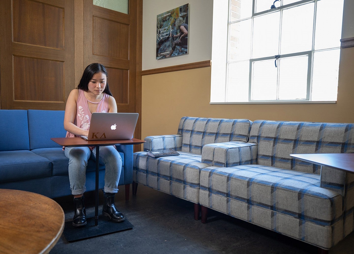 Student sitting in lounge using laptop to study Student sitting in lounge using laptop to study